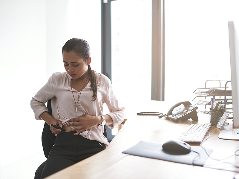 Women injecting insulin in her office