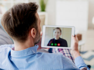 Man on video call with loved one